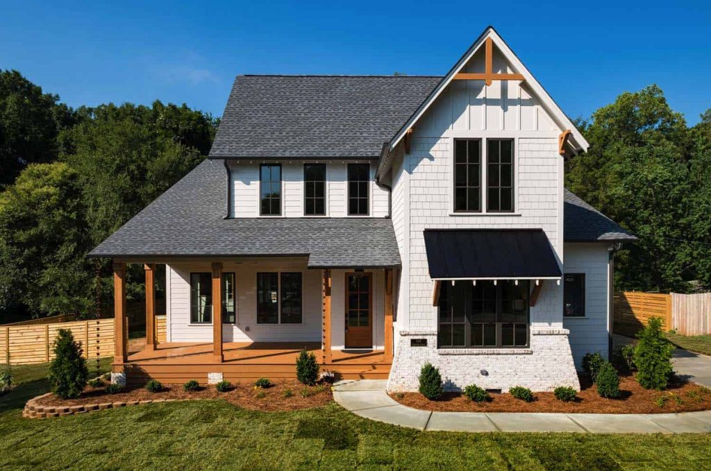 Classic Farmhouse Exterior with Rustic Charm and Large Front Porch