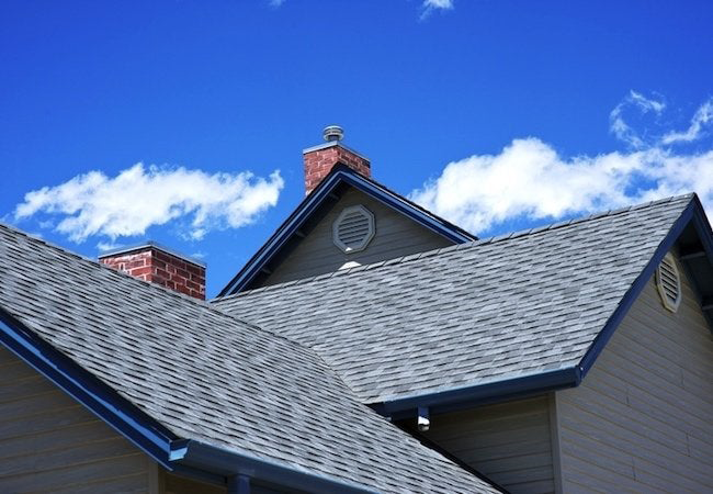 "A skilled roofing crew expertly installing a new roof on a house. The image showcases the dedicated workmanship and attention to detail involved in the roofing process. The team is diligently laying down shingles, ensuring proper alignment and secure attachment. The new roof promises enhanced protection and durability, shielding the house from the elements. This professional installation ensures a sturdy and reliable roof that will provide long-lasting comfort and peace of mind for the homeowners."