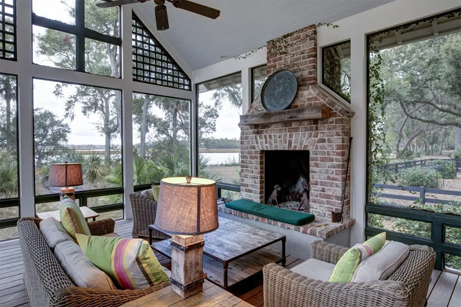 This image depicts a splendid sunroom, complete with a charming fireplace that adds warmth and ambience